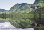 Reflections of shoreline and mountains at Alison Sound
