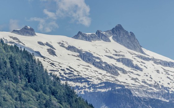 Closeup of snowy mountain peak above