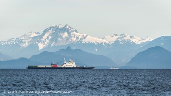 Scenic view of snowy mountains, islands and ferries